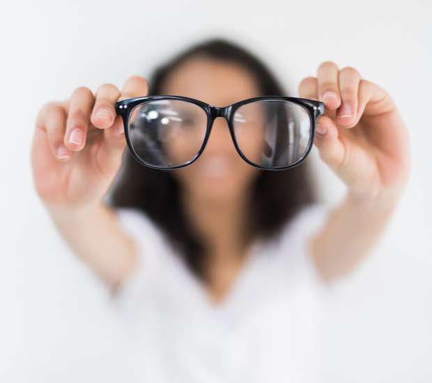 Person holding black glasses